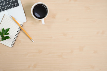 Flay lay, Top view office table desk with computer laptop, keyboard, coffee, pencil, leaves with copy space wood background.