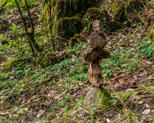 Balanced stone pyramid in green summer forest at vancouver island canada.