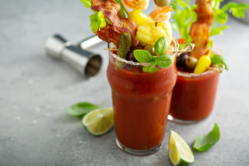 Bloody mary cocktail topped with variety of generous garnishes © fahrwasser