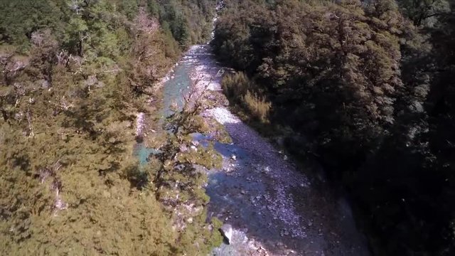 Drone filming over the mountain river on bright summer day