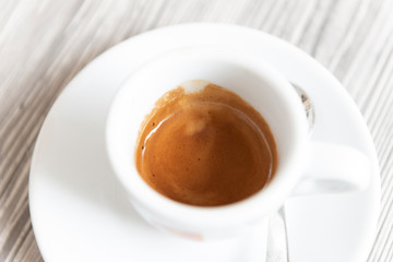 Hot coffee in white cup on table