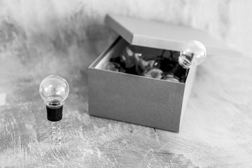 think outside the box lightbulbs inside and a unique one outside on a spring