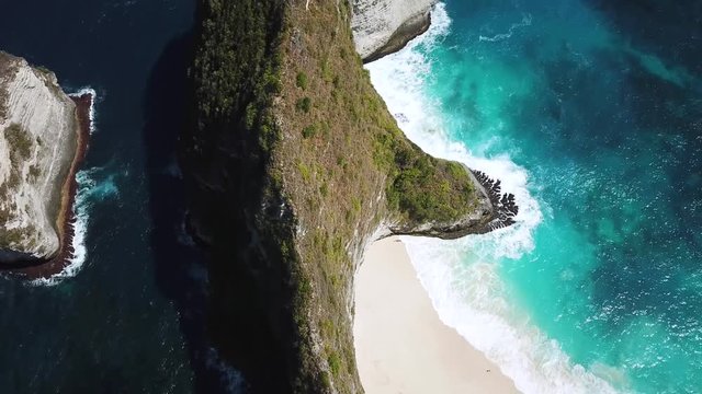 Panning Up drone shot revealing KelingKing Beach and the rest of the beautiful cliffs of the island of Nusa Penida, Indonesia.