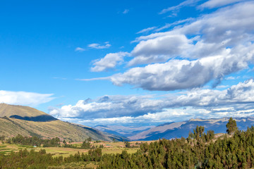 Mountain landscape with fertile valley below steep forests and ancient agricultural terraces at sunset