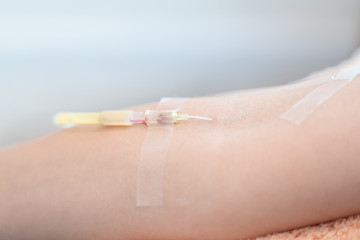 closeup needle injection vitamins and minerals directly into bloodstream