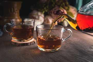 Pouring tea into cup of tea