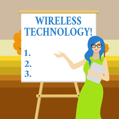 Text sign showing Wireless Technology. Business photo text a technology that allows wireless communication White Female in Glasses Standing by Blank Whiteboard on Stand Presentation