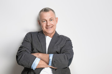 Portrait of handsome middle-aged man on light background