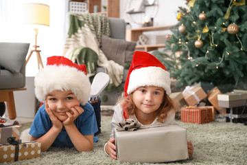 Fototapeta na wymiar Happy children with Christmas gifts at home