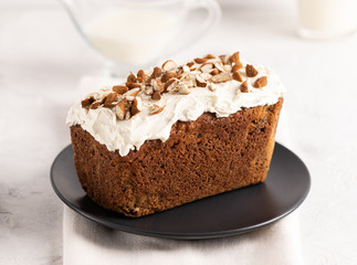 Brown cake with nuts on the plate