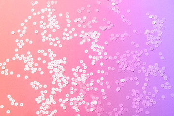 Holographic sparkles on neon colors background. Festive trendy backdrop