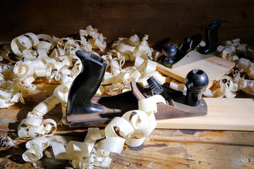 Carpentry tools for wood processing, shavings on a wooden table.