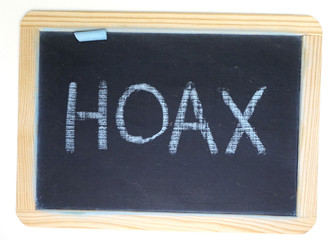 Hoax and fake message on chalkboard
