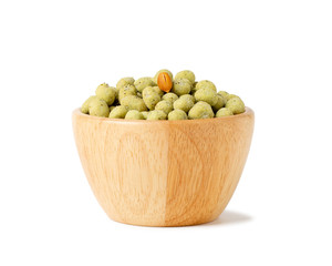 wasabi crispy peanut snack balls in a wooden cup isolated on white background.