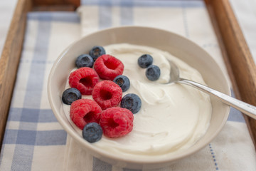 healhty greek Yogurt with fresh berries for breakfast on a table