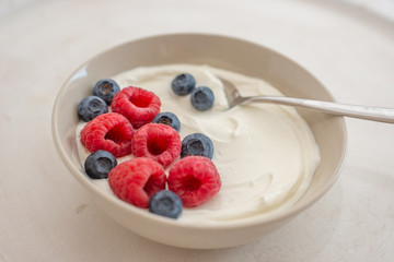 healhty greek Yogurt with fresh berries for breakfast on a table