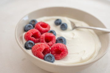 healhty greek Yogurt with fresh berries for breakfast on a table