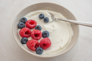 healhty greek Yogurt with fresh berries for breakfast on a table