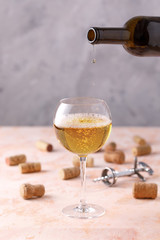 White wine is poured into a glass. The concept of winemaking. Place under your text.