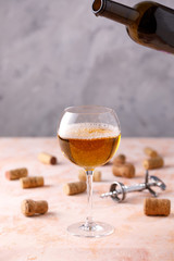 White wine is poured into a glass. The concept of winemaking. Place under your text.