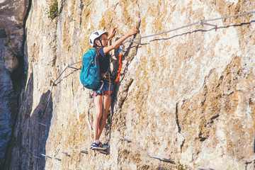 Kid girl climbing mountain. 