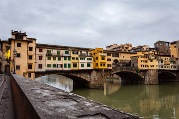 Fototapeta na wymiar Ponte Vecchio in Florence Italy. Early winter morning in Florence. Rain In The Old Town. Deserted Ponto Vecchio. Medieval city.