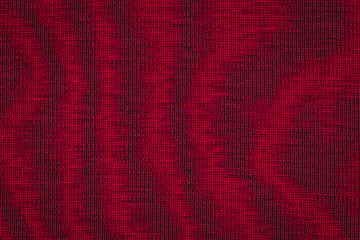 Texture of real  dark burgundy knitwear, textile background. Dark red knitted background