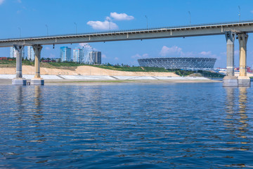 View on the famous dancing bridge and Volgograd Arena stadium in Volgograd from the water of Volga river in the hot clear sunny summer day