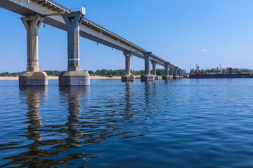 View on the famous dancing bridge in Volgograd from the water of Volga river in the hot clear sunny summer day