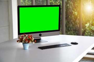 set of monitor, keyboard and mouse decorated with flower beside windows