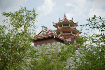 Fototapeta na wymiar a large Buddhist monastery and huge pagoda and ornaments typical of China with bamboo as a framming foreground located on Tanjung Pinang, Riau Islands