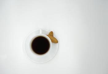 Cup of coffee with biscuits on white background