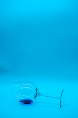 Wineglasses with blue curacao on blue background