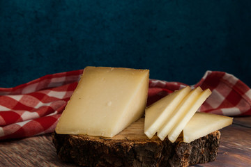 piece and slices of typical Spanish Manchego cheese