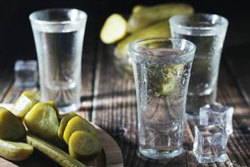 Three shots with vodka and pickled cucumbers	 - obrazy, fototapety, plakaty