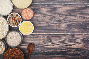 A set of bowls filled with different seeds: buckwheat, rise, corn and oatmeal