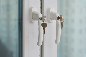 Protecting a child from falling out of windows. Handle with a lock on the window