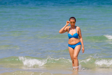 Fototapeta na wymiar Woman show bikini blue idyllic on blue water