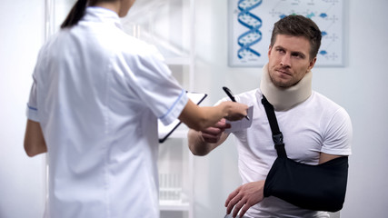 Doctor giving bill to patient in arm sling and foam collar, expensive treatment