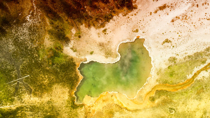 Yellowstone Geyser as seen from above. Pool in the middle of the forest, Wyoming