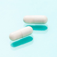 White medicine capsules probiotic powder inside. Close up. High resolution product. Health care concept - Image