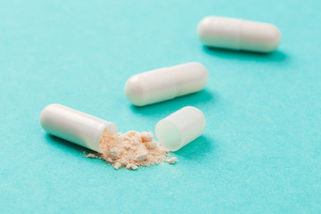 White medicine capsules probiotic powder inside. Close up. High resolution product. Health care concept - Image