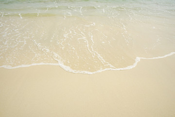 Tropical beach with white coral sand and calm wave with space for text background                   