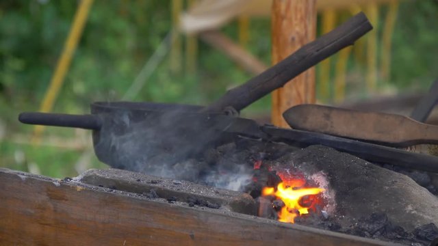 Medieval kitchen smoke and fire burning with pan and old wood