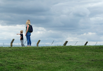 Young blonde single mother with young son outdoors