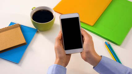 Male holding smartphone with black screen in office, business app, template