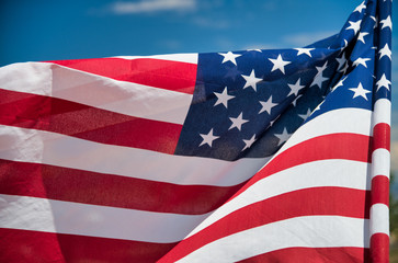Waving American Flag on blue sky background