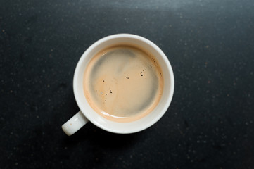 black coffee on white cup in mini cafe