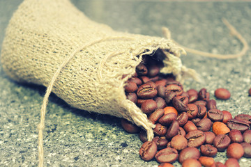 Coffee beans. Roasted coffee beans in a coarse woven bag.