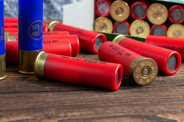 12 gauge caliber color cartridges hunting shells box pack on a brown wooden background